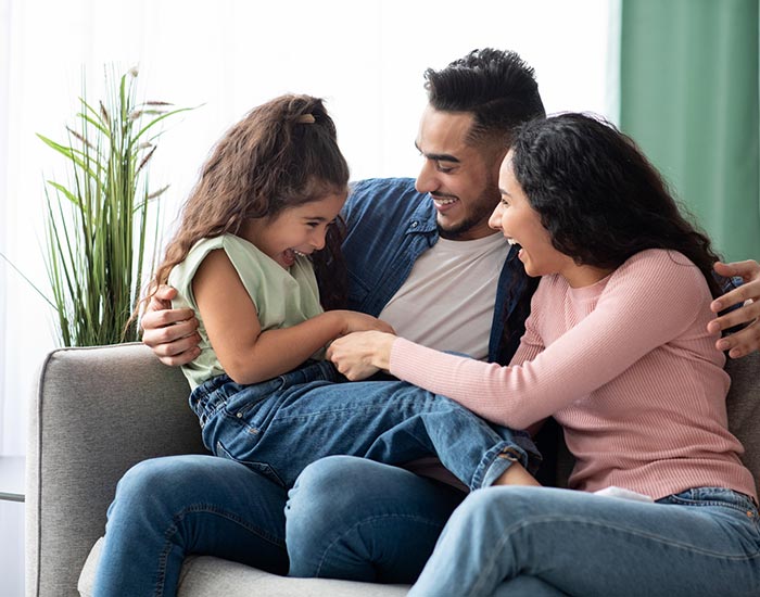 A young family playing in their living room