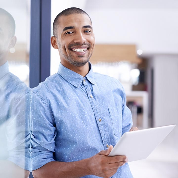 Man in an office with a smart tablet