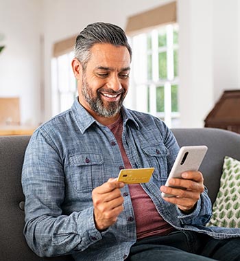 A man using a credit or debit card on a smartphone