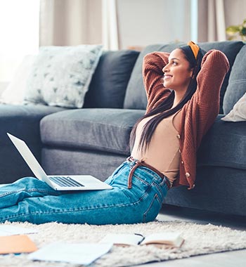 A lady in her living room using a laptop computer