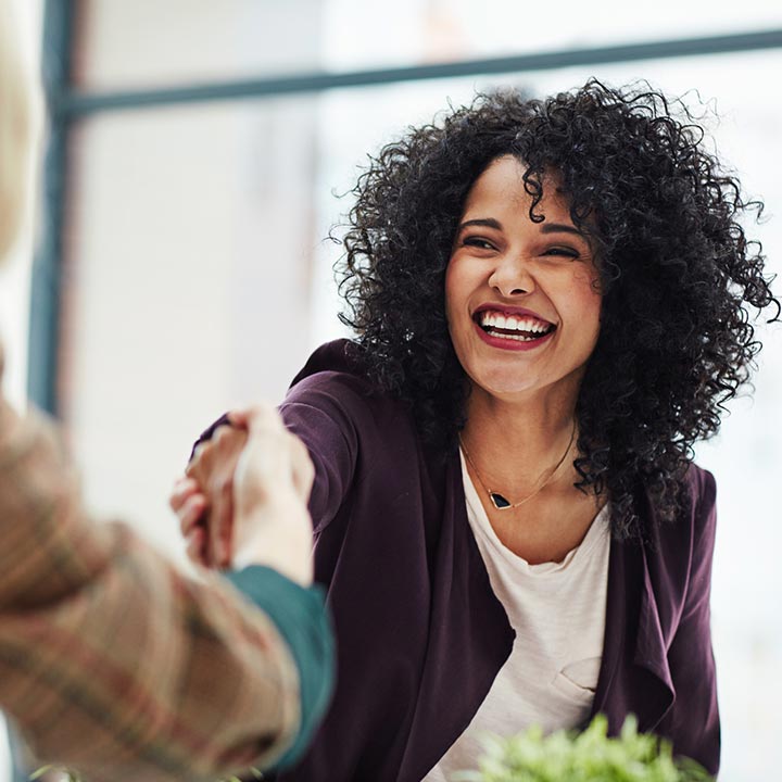 A lady shaking hands in an office