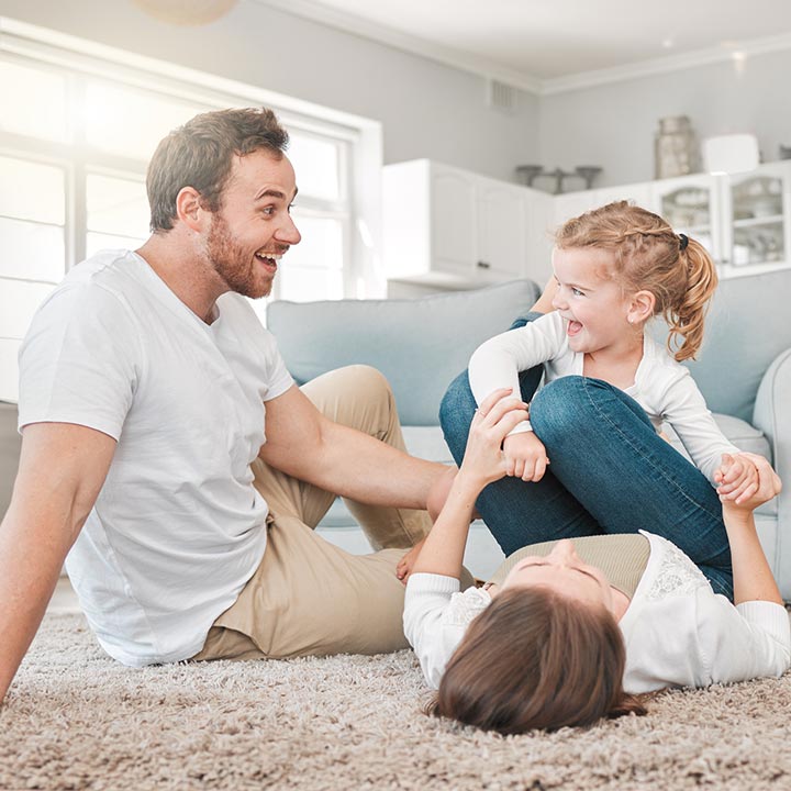 Young family playing in their living room