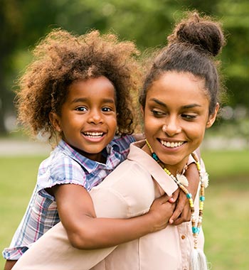 A mother and child playing in a park