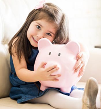 A little girl with her piggy bank